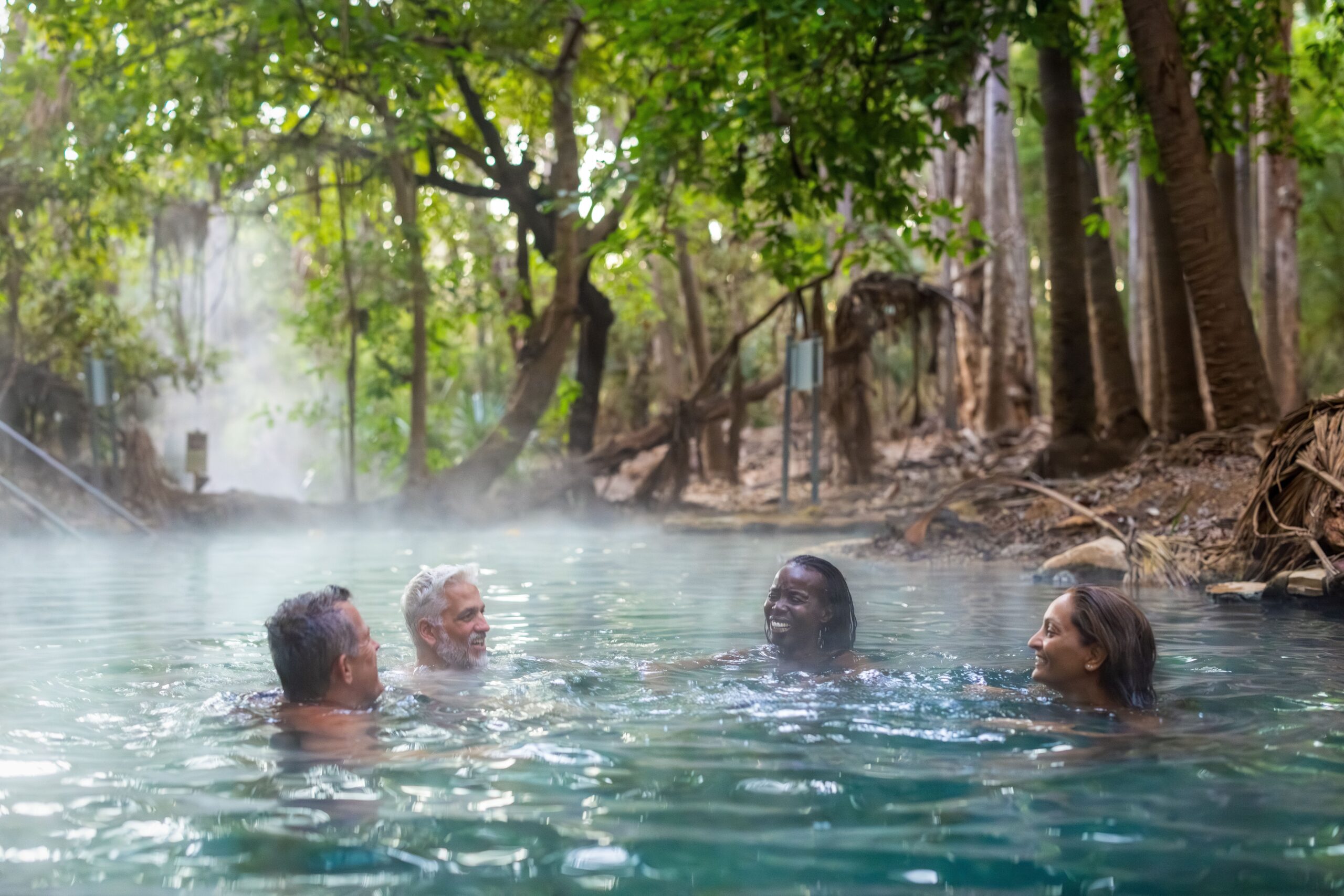 A Group Of Friends Swimming In Mataranka Hot Springs.